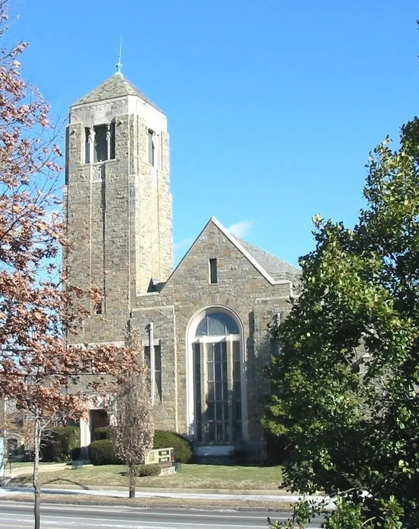 The stone bell tower and arched front window of Sixth Presbyterian Church