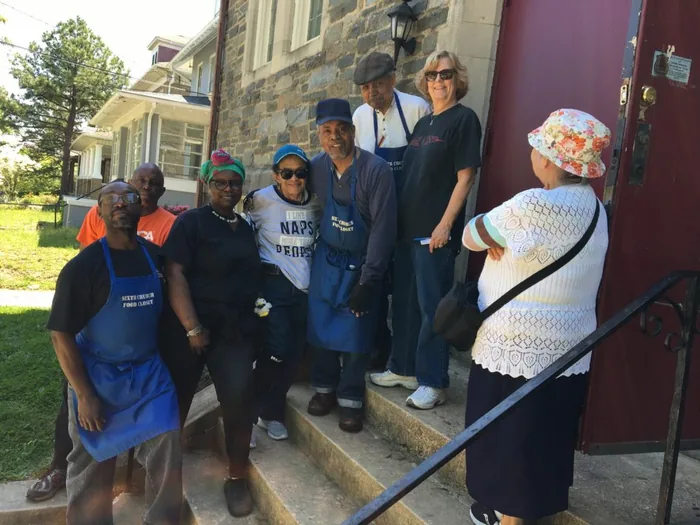 Food Closet volunteers standing together with boxes of donated food at Sixth Presbyterian Church