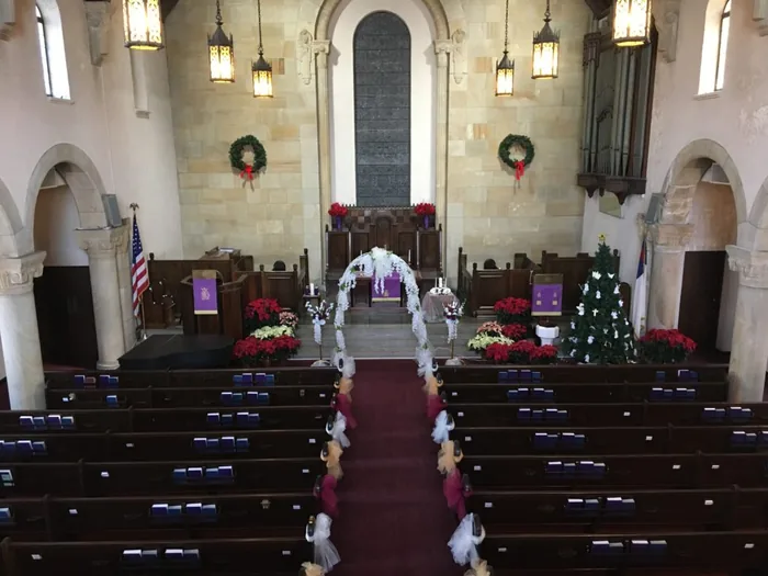 A wedding ceremony taking place in the sanctuary at Sixth Presbyterian Church